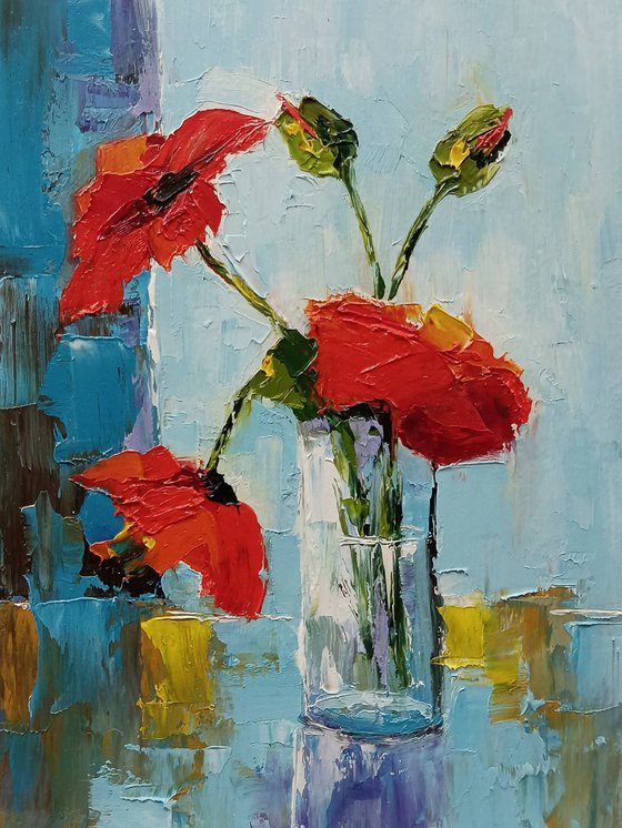 Red poppy in glass