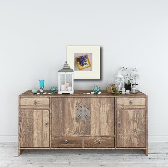 Blue plums on a yellow dish