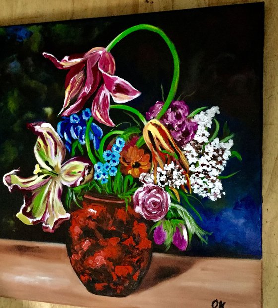 Bouquet of flowers in a clay vase.