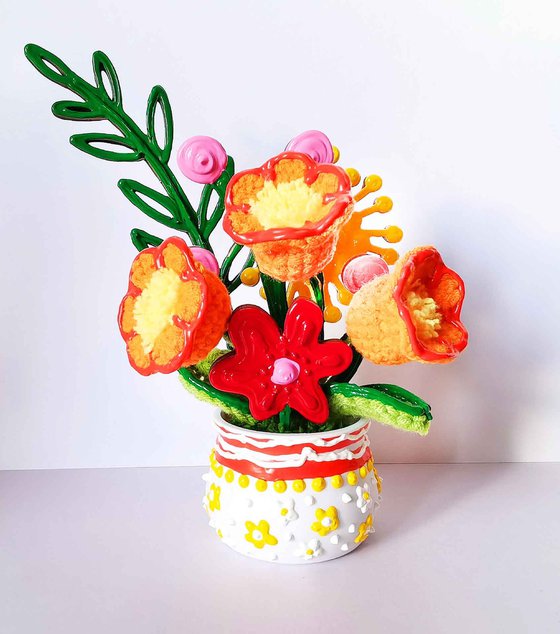 Orange crochet flowers in vase