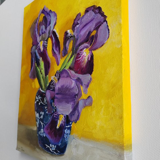 Purple iris bouquet on yellow background