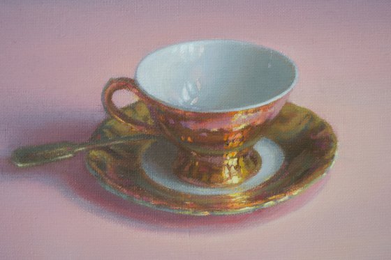 Coffee cup on pink tablecloth