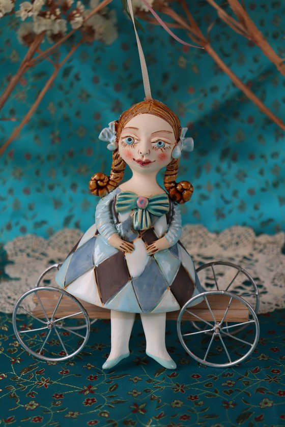 Little Girl in Blue Harlequine Dress. Tiny hanging sculpture