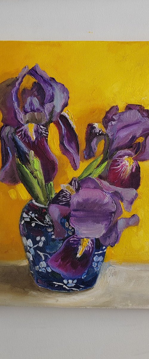 Purple iris bouquet on yellow by Leyla Demir