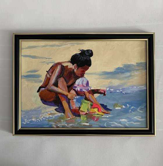 Mom with a kid on the beach.