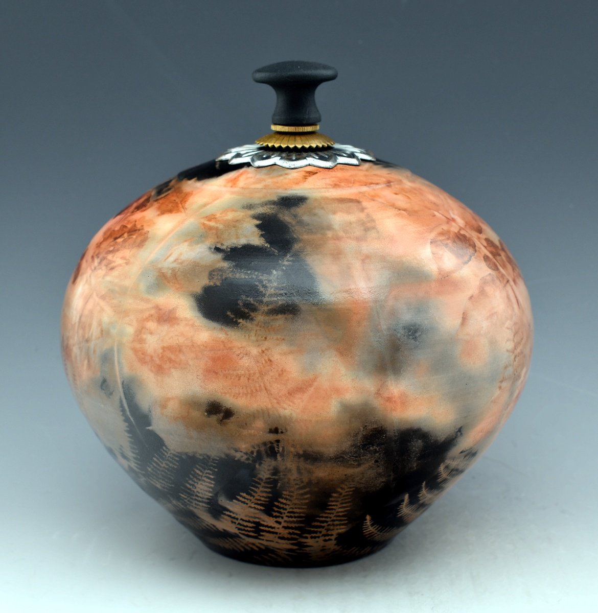 Burnished 260 Fossil covered vessel with additions. by Ron Mello