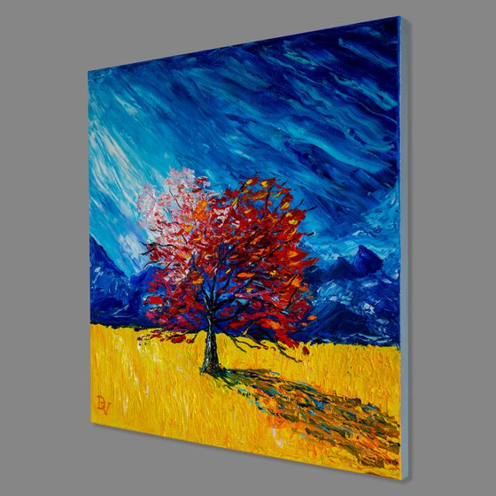 Red tree in a yellow field