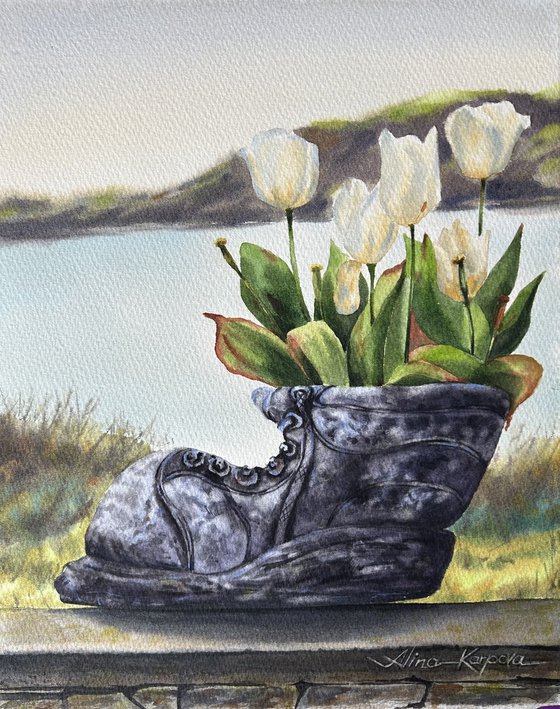 White tulips in old shoe planter sea view