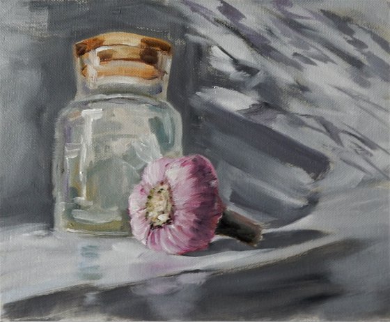 Glass jar and garlic. Still life.