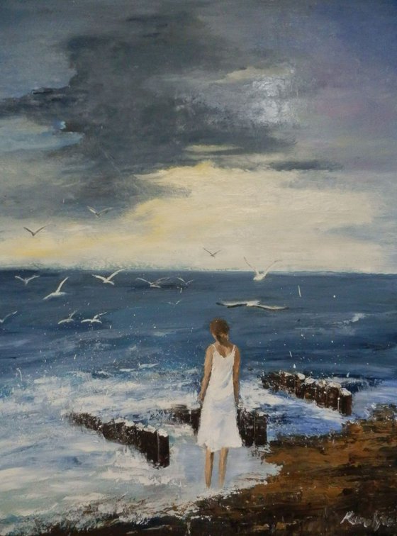 Seagulls and a lonely woman at seashore