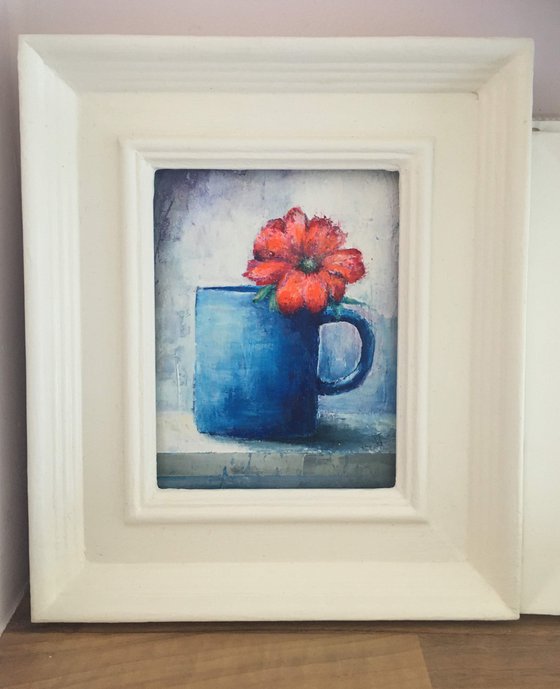 Orange Flower in Blue Mug.