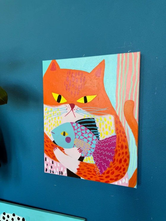 Orange Cat with Colorful Fish
