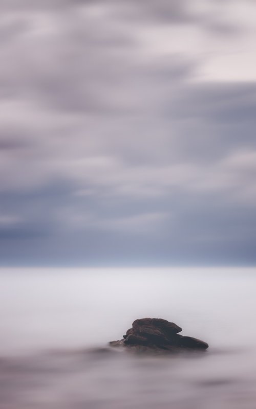 A lone rock in the silky sea by Karim Carella