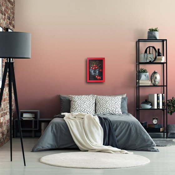 Red cherries in a metal cup