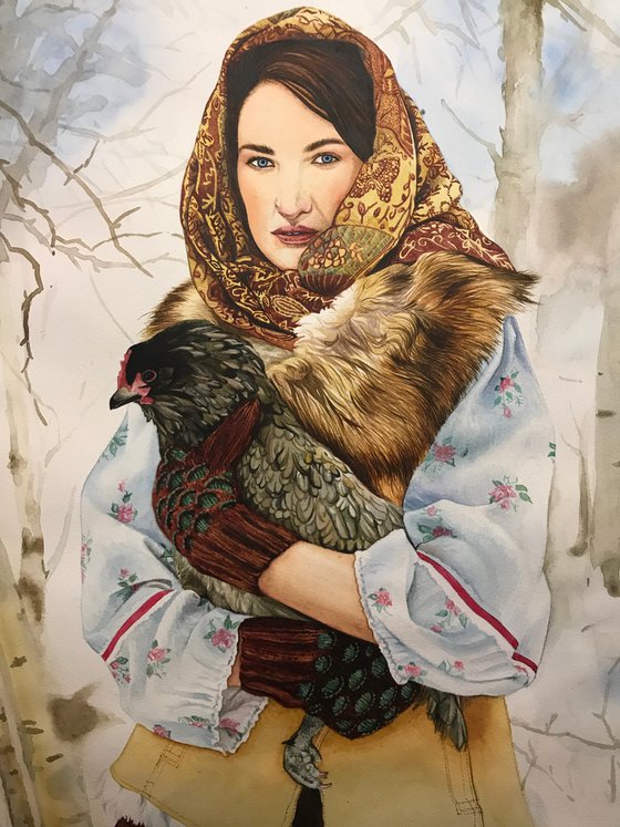 Girl in national clothes with a chicken in her hands