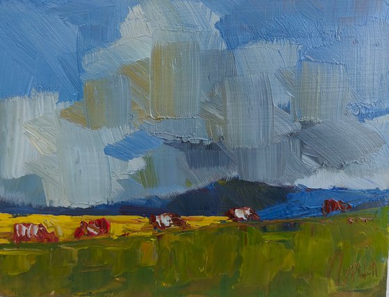 Landscape with clouds and cows