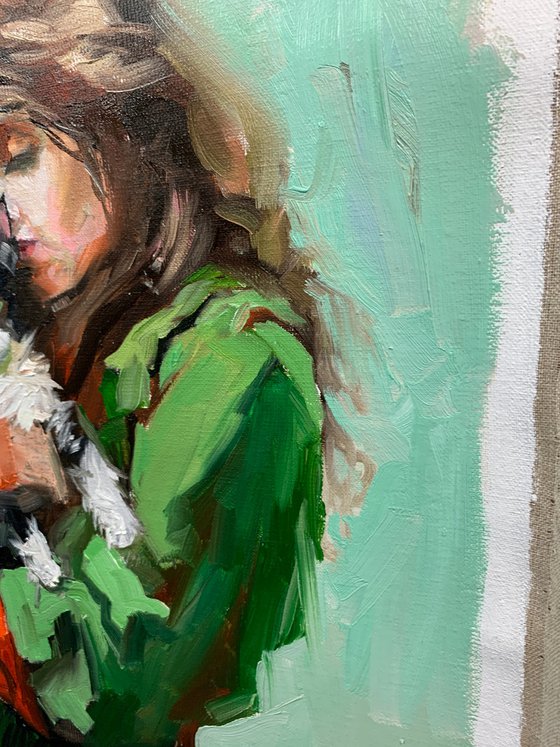 Girl in green dress with cat.