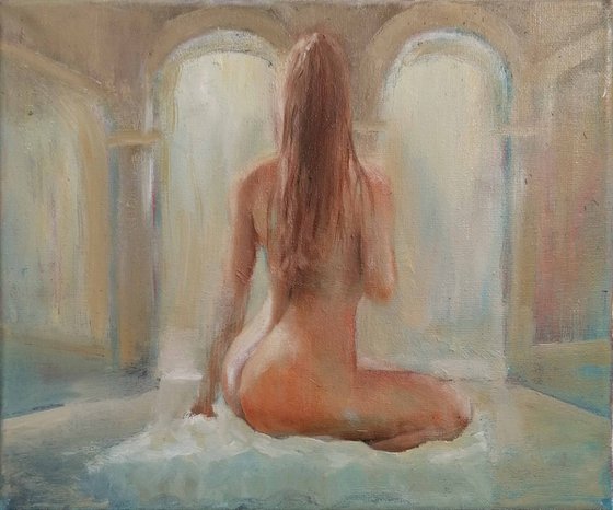 Nude woman seated by the pool