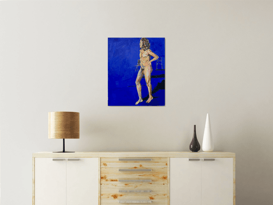 Young nude man in blue room