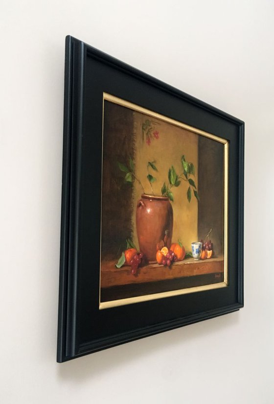 Still life with flower pot, tanderines and grapes. Framed painting. Oil on linen