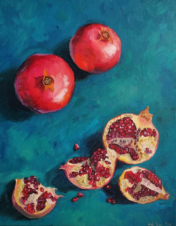 Pomegranate slices and seeds on deep blue bakground