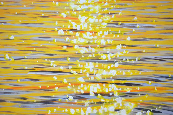 Gold sparks on the water.