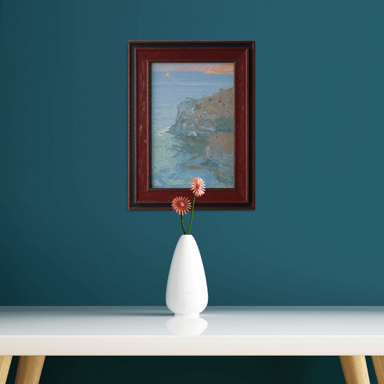 A lonely white sail gleams