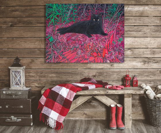Black cat on a carpet of red leaves