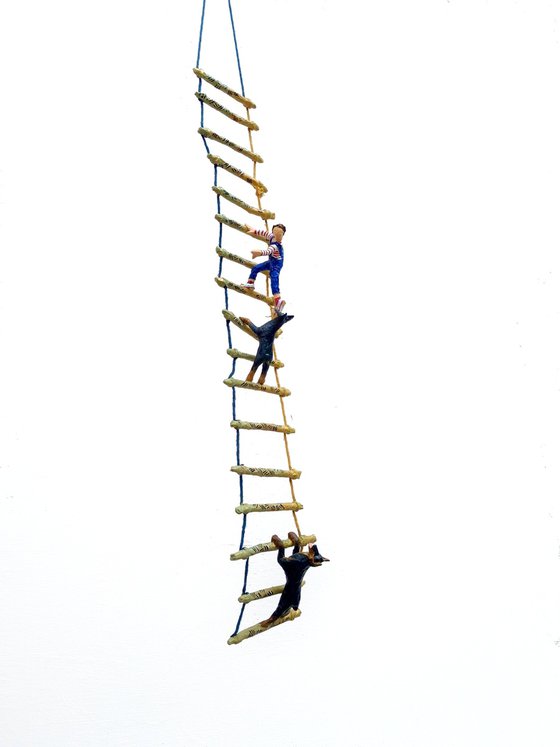 Two Dobermans on ladder