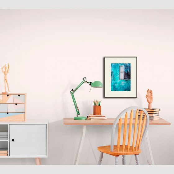 A window in a turquoise wall