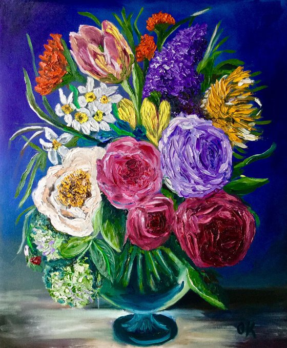 Bouquet of flowers.  Roses, tulips, daffodils, lilac, hydrangeas in a vase.