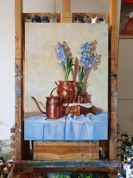 "Blue hyacinths in copper jugs."