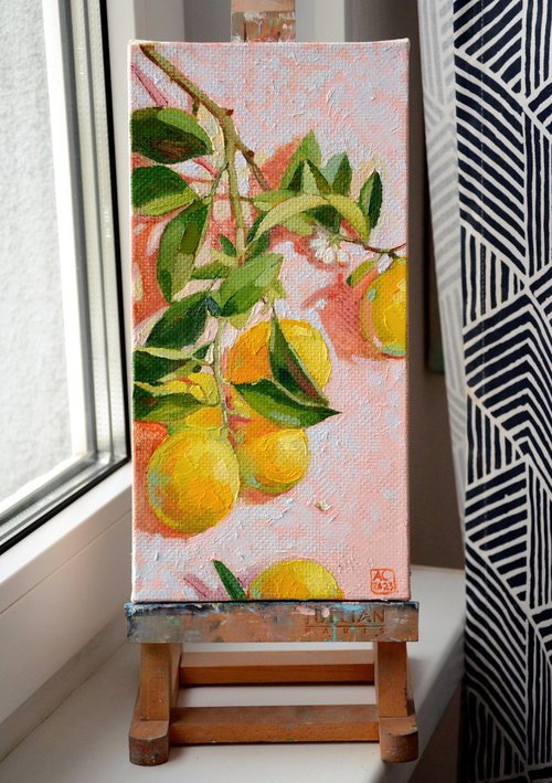 A branch of lemons on a light pink background with green leaves by Alexandra Sergeeva