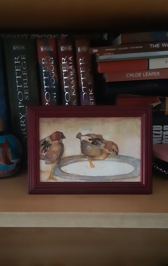 Two chicks with a tin plate