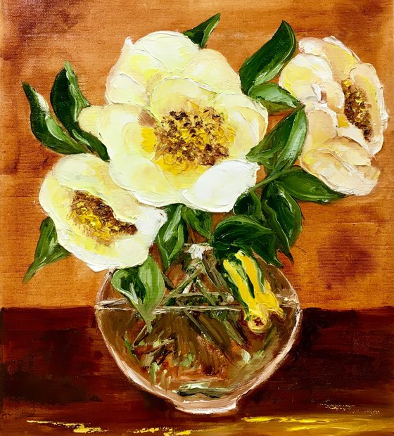 Bouquet of wild yellow roses in a vase on wooden table.