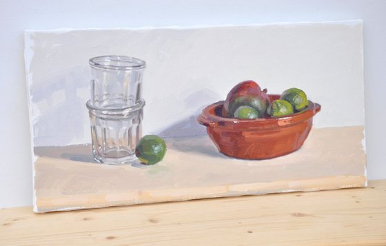 Limes and mango in an earthenware dish, jam jars