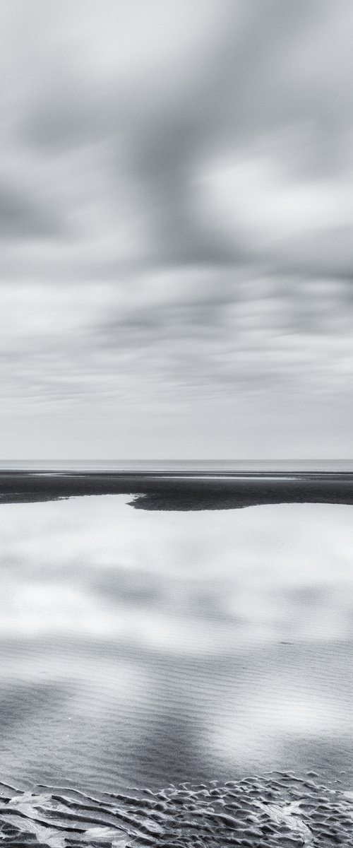 Low tide and reflected clouds by Karim Carella