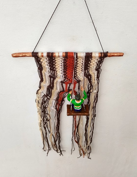 Boy on the macrame wall hanging