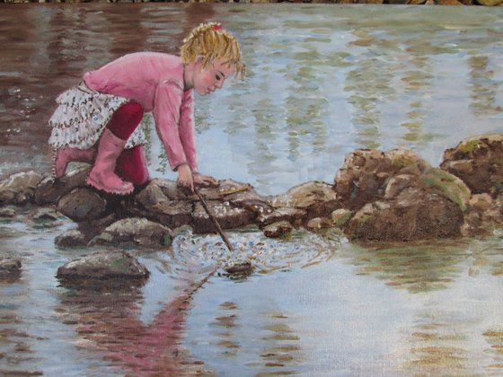 Girl playing by a lake