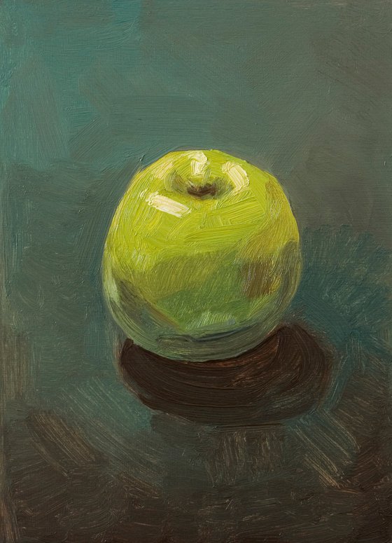 still life of fresh green apple on a blue background