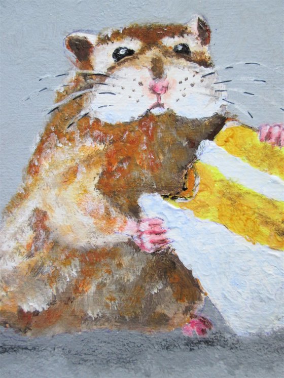 Hamster snacking on cake