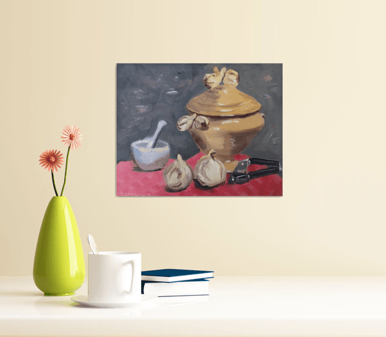 A garlic tureen, pestle and mortar and a press, oil painting.