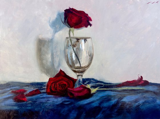 Red rose in empty glass