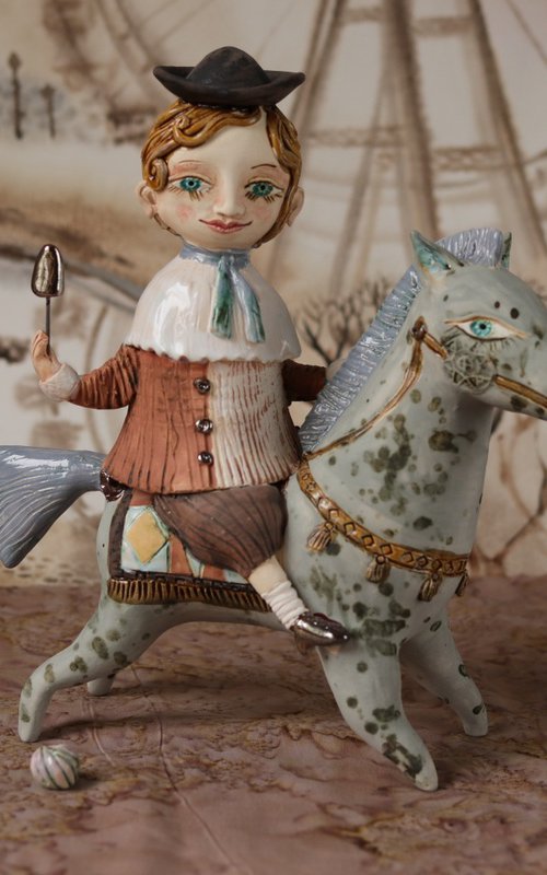 Vintage dressed boy riding a blue horse. From "Le Carousel, Hommage à l'Innocence" project by Elya Yalonetski by Elya Yalonetski