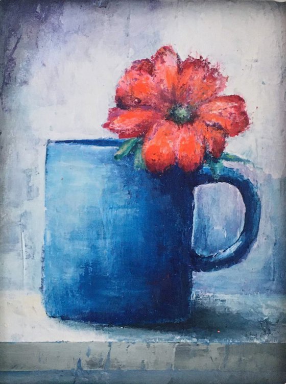 Orange Flower in Blue Mug.