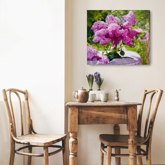 Lilac bouquet in a glass vase in the garden still life