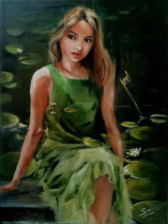 Girl sitting  by the pond