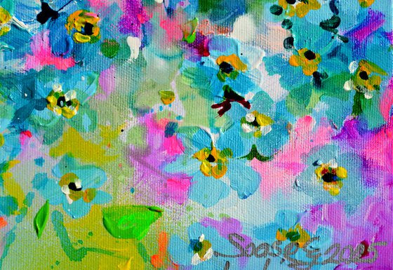 Forget me not flower field at sunrise