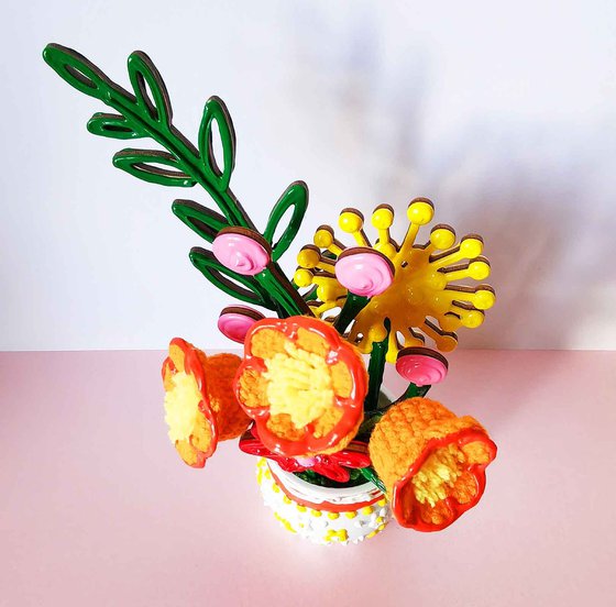 Orange crochet flowers in vase