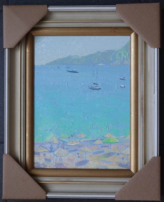 Yachts and umbrellas on the beach